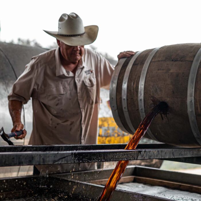 Dumping bourbon from a barrel